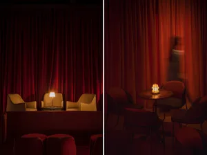 A cozy coffee shop with red curtains and modern seating arrangement.