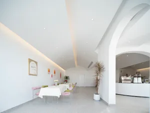 Bright and minimalist dining room with white furniture and walls