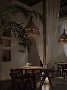 A rustic restaurant interior with wooden furniture, hanging wicker lights, and minimalist decor.