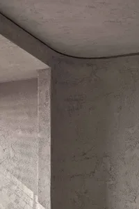 A minimalist architectural design featuring textured concrete surfaces.