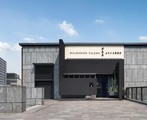 A minimalist restaurant exterior featuring a glass facade and modern design.
