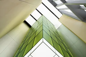A modern architectural design featuring glass and metal materials.