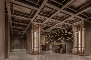 A contemporary office space featuring wooden paneling and concrete columns.