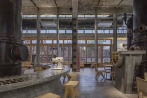 Industrial-style coffee shop with concrete bar and seating area.