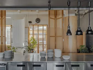 A modern industrial commercial interior with minimalist design and wooden accents.