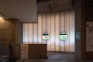 A modern art deco design featuring glass panels and circular windows.