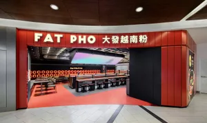 Interior of a modern food court with metal and red color scheme.