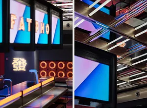 A vibrant and modern restaurant interior with colorful neon signs.