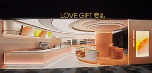 A modern retail interior with a stylish, orange-accented counter and coffee shop setup.