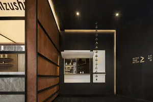 Modern bar interior with wooden walls, marble bar counter, and hanging decor
