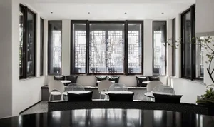 A modern cafeteria featuring glass walls, a concrete floor, and comfortable pillows