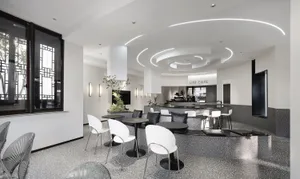 Modern interior design of a coffee shop featuring concrete and glass materials.