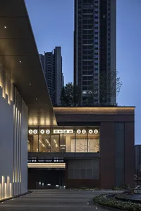 Modern restaurant exterior with brick, concrete, and warm lighting.