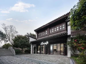 A traditional wooden cafe exterior with stone walls and a tiled roof.