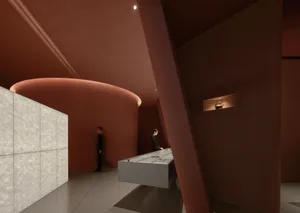 A modern lobby interior featuring concrete walls and a circular column with a light fixture.