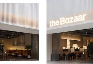 A modern restaurant interior with warm lighting and minimalist design.