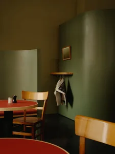 Cafe interior with wooden furniture and concrete walls