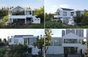 Modern exterior of a cafe with white painted walls and glass elements.