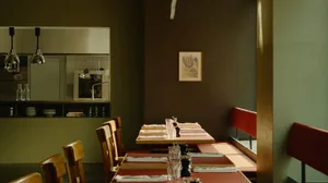 A modern restaurant interior with wooden tables and chairs