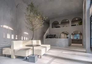 Modern coffee shop interior designed with concrete materials