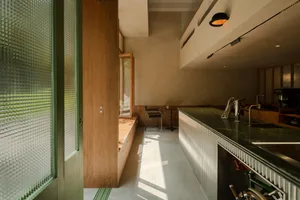 Modern kitchen featuring a green quartzite countertop and minimalist design elements.
