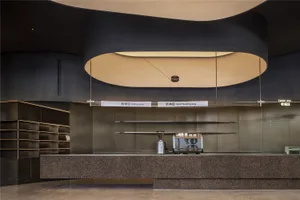 Industrial design coffee shop interior with metal counter and minimalist decor.