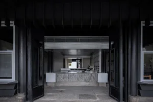 A minimalist coffee shop interior with a concrete counter.