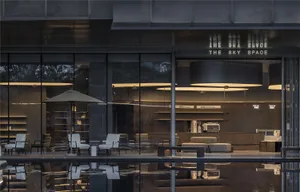 A modern coffee shop with sleek, minimalist interior design featuring contemporary furniture and lighting.