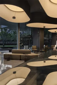 Modern hotel lobby with large glass walls and contemporary furniture.