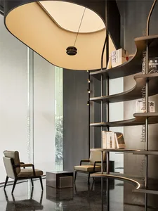 A modern library with metal shelving, glass panels, and comfortable seating.