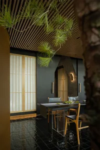 A minimalist restaurant dining room featuring wooden decor and accents.