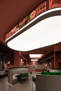 Modern restaurant interior with sunken seating area and concrete floor