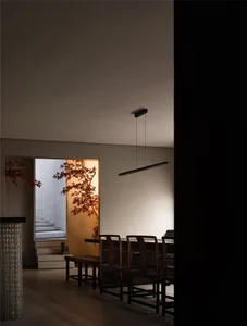 A minimalist interior design featuring wooden furniture and warm lighting.