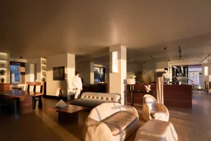 Modern living room featuring neutral-colored furniture and a cozy ambiance.