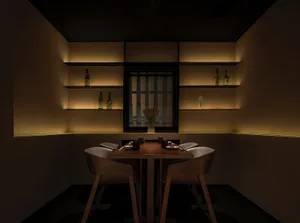 Modern dining room with wooden furniture, chairs, and a table set with plates and utensils.
