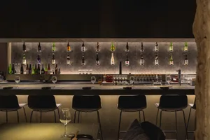 Modern, sleek bar counter featuring metallic surfaces and minimalist design.