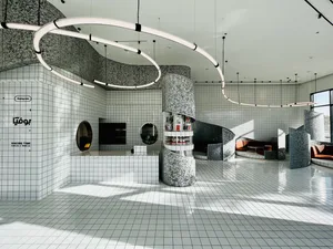 Modern coffee shop interior with tiled flooring, concrete and steel elements