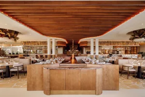 A modern restaurant bar with wooden decor and seating.