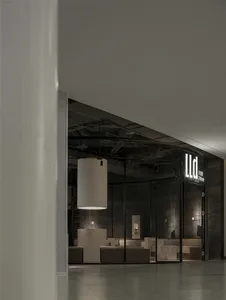 A modern retail storefront with a metal frame and illuminated signage.