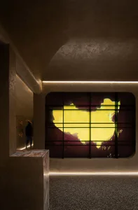 A modern lobby featuring a metallic window with a reflective surface.