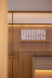 A modern restaurant interior with wooden panels featuring a menu card.