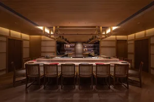 A wooden restaurant interior with a bar area and clean, minimalist design.