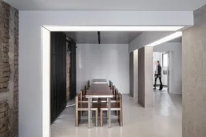 Industrial-style dining area with concrete, metal, and wooden furniture and flooring