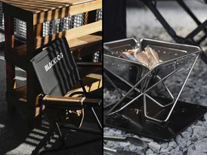 A metal outdoor folding burner with wood being burned inside.