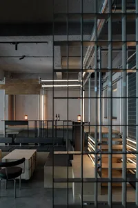 An industrial-style restaurant interior featuring concrete and steel materials.