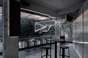 Indoor restaurant with metallic seating and tables, industrial design elements