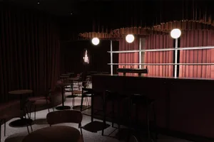 A photograph of a modern restaurant interior with fabric curtains.