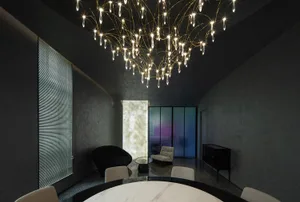 Modern dining room featuring metal, glass, and marble materials.