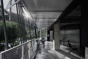 Modern industrial balcony in an airport concourse with metal and concrete retaining walls