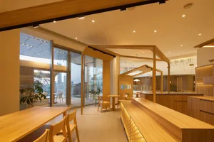 Modern cafe interior featuring wooden seating arrangements.